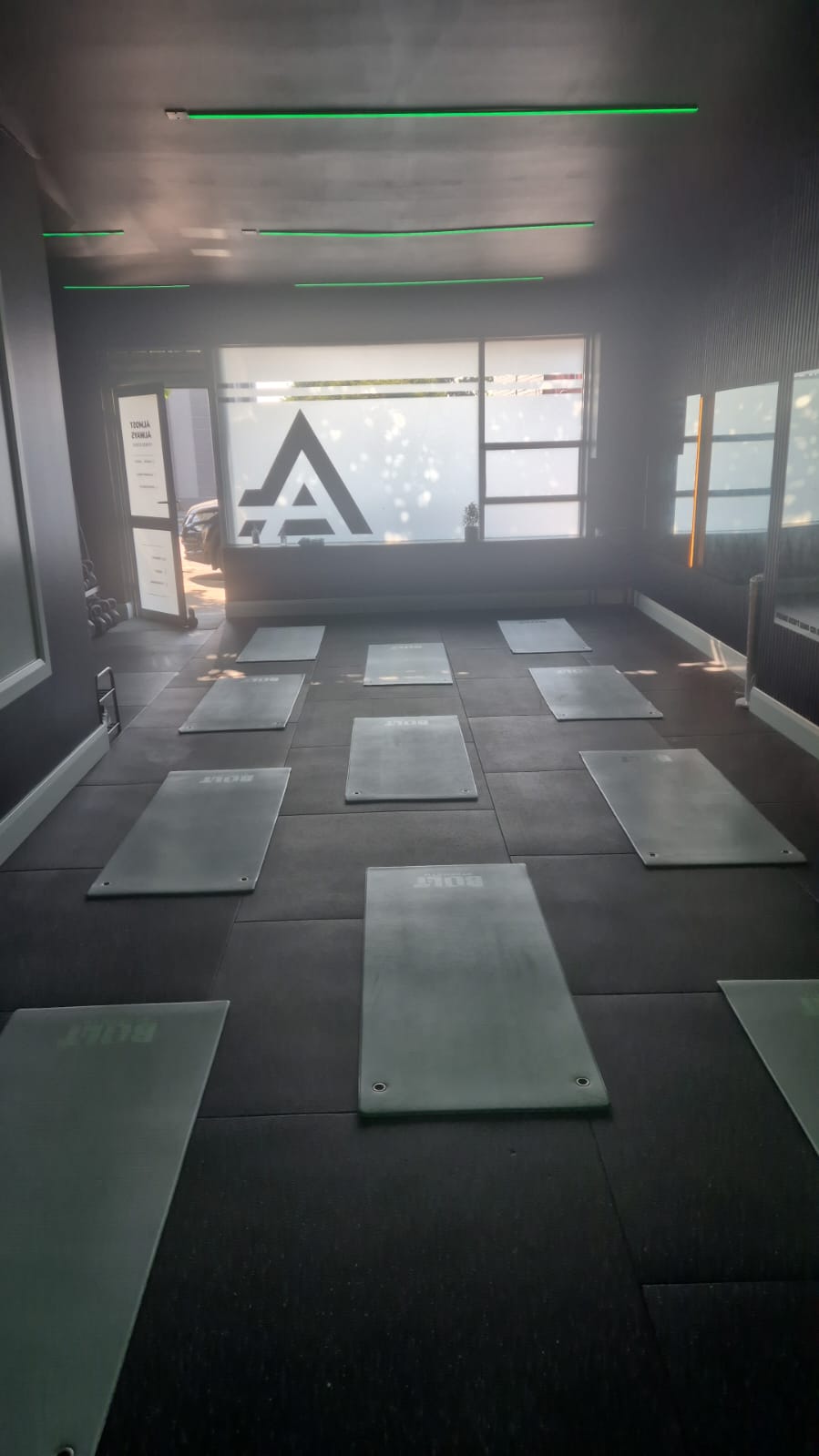 Studio floor in daylight with mats laid out for class
